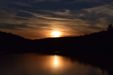 Forest, lake and sun set