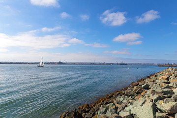 Sailing boat in San Diego Harbor waters. Beautiful harbor panorama before sunset.