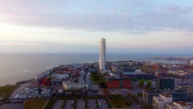 Flying towards the skyscraper (Turning torso) with a birds view of west harbor (v&radic;&sect;stra hamnen) in Malmoe, Sweden in 4k.