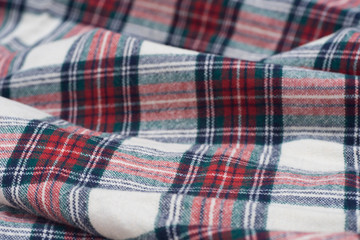 folded creased multicolored checkered woolen fabric background