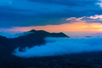 Fototapeta na wymiar Beautiful dramatic sunset in the mountains. Landscape lot of fog Phu Thok Mountain at Chiang Khan ,Loei Province in Thailand.
