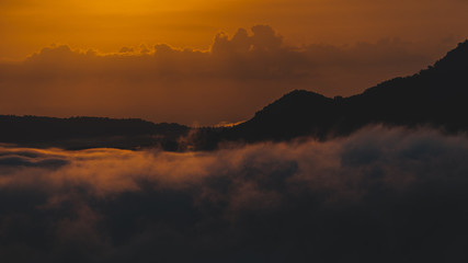 Beautiful dramatic sunset in the mountains. Landscape lot of fog Phu Thok Mountain at Chiang Khan ,Loei Province in Thailand.