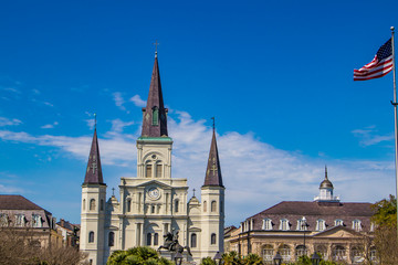 Panoramic View of the St. Louis Cathedral, the Andrew Jackson Statue, and the Presbytere Museum with the American Flag in the Right Corner in Jackson Square, New Orleans, Louisiana, USA
