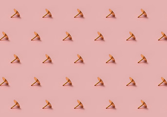 Golden tack pattern on pink background