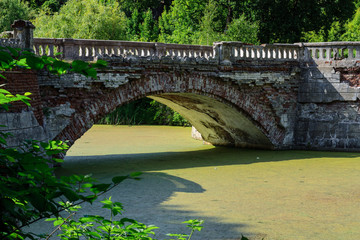 Fototapeta premium Sharovka, Kharkov reg / Ukraine brick bridge over the pond.