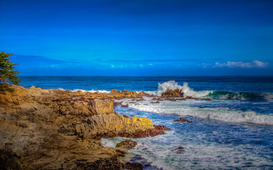 Pacific Ocean waves crashing on the rugged Northern California coastline in  Monterey