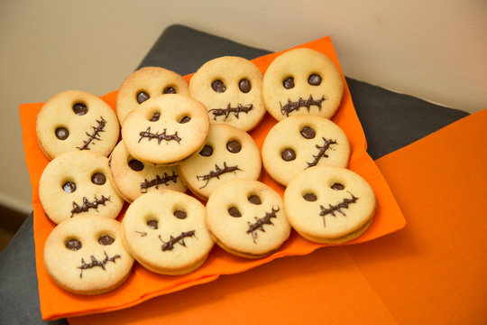 horizontal image with detail of face shaped halloween party cookies