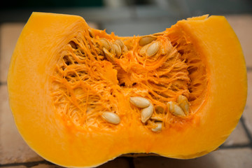 horizontal image with detail of an orange pumpkin cut in half