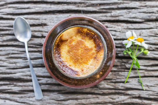 Latte Coffee in Glass with Daisy Flower and Spoon on Wood Table Flatray or Top Table