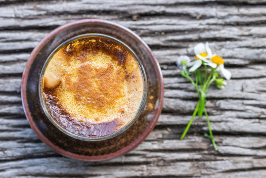 Latte Coffee in Glass with Daisy Flower on Wood Table Flatray
