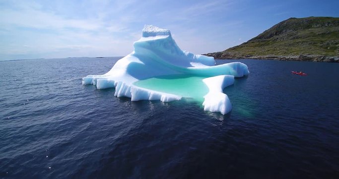 Iceberg with kayakers