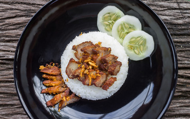 Thai Food Fried Pork with Garlic and Cucumber in Black Dish Flatray or Top View Wide