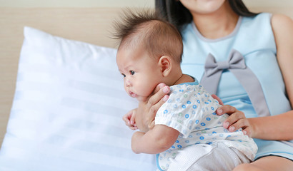 Health care after meal. Mother is belching for infant baby. 