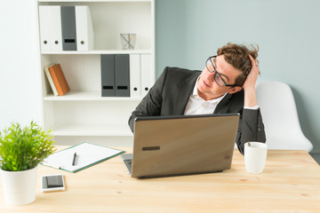 Humor, joke and business people concept - funny man tired after working on computer in office