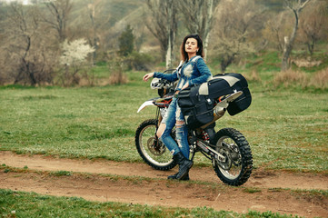 A young girl mototourist in nature . Motorcycle travel concept