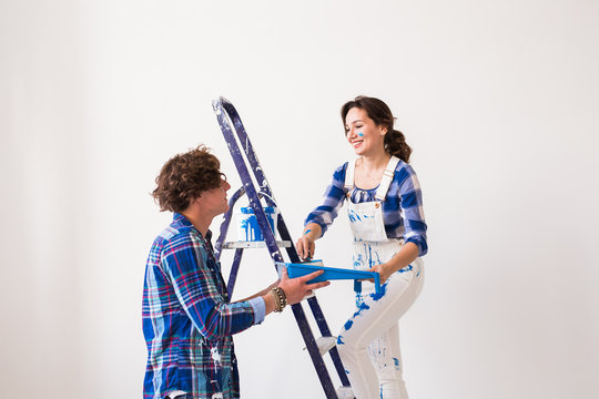 Teamwork, renovation and repair concept - Portrait of funny couple doing redecoration in apartment