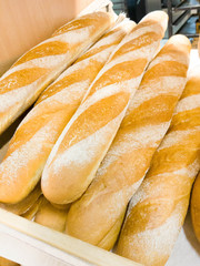 Bread baguettes in a basket in the baking shop