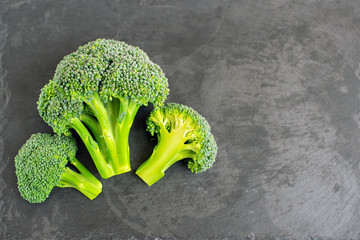 Fresh broccoli on black background. Top view