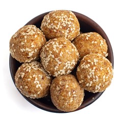 Energy bites in brown bowl. Isolated on white background. Top view