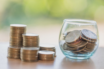 Coin in glass bottle with money stack step up growing growth saving money, Concept financial business investment.