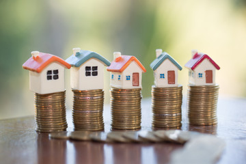 Mini house on stack of coins,Money and house,  Mortgage, Savings money for buy house and loan to business investment for real estate concept. Invesment and Risk Management.