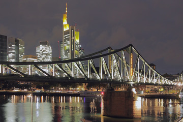 Fototapeta na wymiar River, bridge and city at night. Frankfurt am Main, Germany