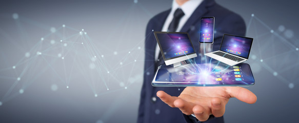 Modern devices connected in businessman hand 3D rendering