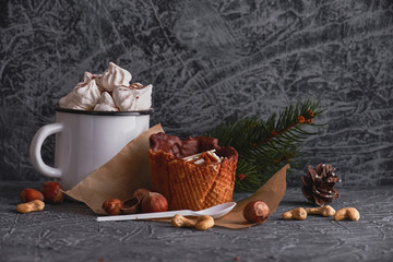 Delicious dessert. A sweet cake and a cup of cocoa on a gray texture background.  Holiday delicious breakfast. 