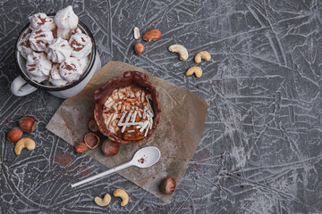 Delicious dessert. A sweet cake and a cup of cocoa on a gray texture background.  Holiday delicious breakfast. Top view