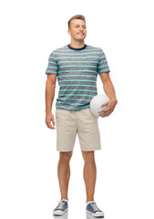 Fototapeta premium sport, leisure and people concept - smiling young man with volleyball over white background