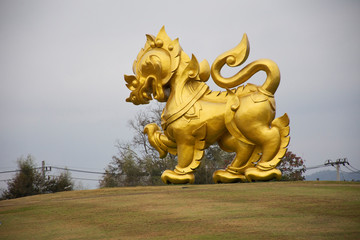 Gold Singha statue on hill in Singha Park at Chiangrai city in Chiang Rai, Thailand