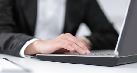 closeup of business woman typing on a laptop