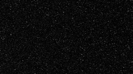 Snowstorm texture. Bokeh lights on black background, shot of flying snowflakes in the air .  First Snow.