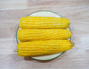 Corn and corn on a wooden table