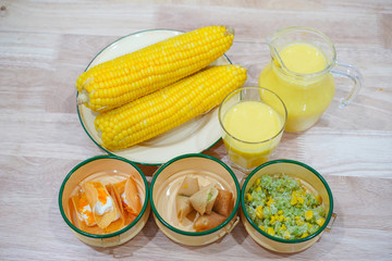 Corn and corn on wooden tables and desserts