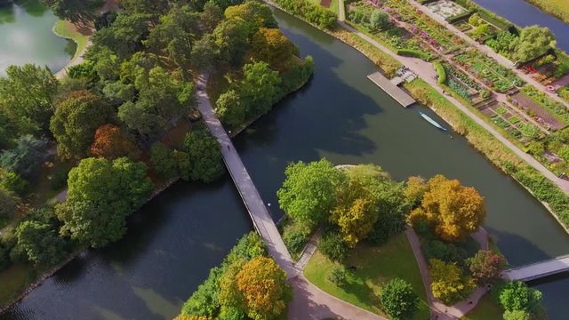 Birds view of a park (slottsparken) in Malmo, Sweden with a bicycle on a bridge over a canal in 4k.