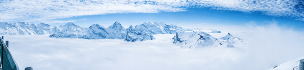 Fototapeta na wymiar Stunning Panoramic view snow mounain of the Swiss Skyline from Schilthorn, Switzerland