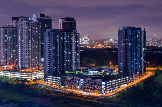 Dark city scene, night hours, light is on in the houses, the end of the day. Skyline Cyberjaya, Malaysia. © Lina