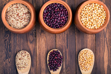 The concept of natural healthy food. Grains of various beans in a large ceramic pots, closeup. Superfood