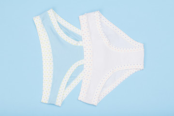 Beautiful women's cotton panties on blue background.