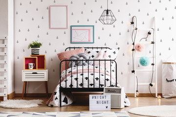 Grey raindrops on white wall of scandinavian kid's room with industrial bed, wooden nightstand and white ladder with light bulbs © Photographee.eu