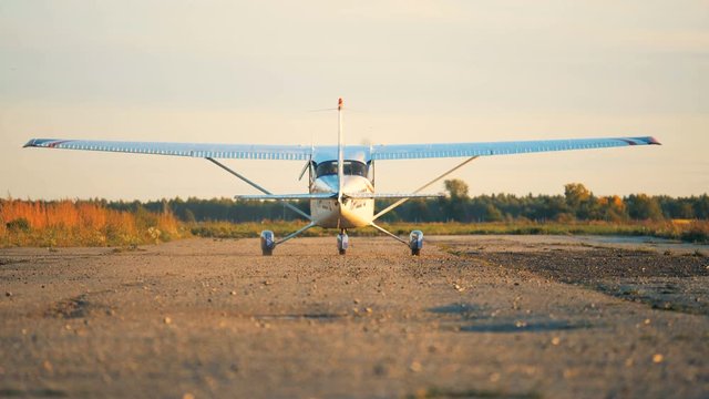 Airplane moving on a airfield, back view.