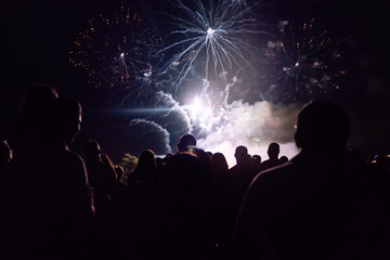 New year concept - cheering crowd and fireworks