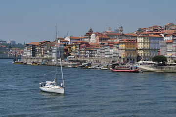 Fototapeta na wymiar Duoro river Portugal with sailboat and Porto city behind
