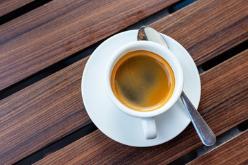 Hot coffee on wood background.
