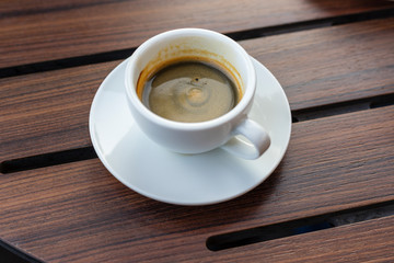 Hot coffee on wood background.