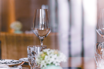 Table setting in a French restaurant. View through a window from a street.