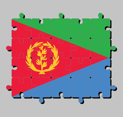 Jigsaw puzzle of Eritrea flag in tricolor of green red triangle on blue and green triangle with olive branch on gold color. Concept of Fulfillment or perfection.
