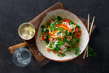 Vegetarian Thai noodles dark stone background top view