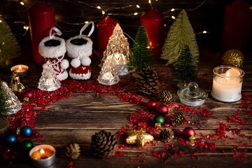 Christmas background with decorations on wooden table with warm lighting.